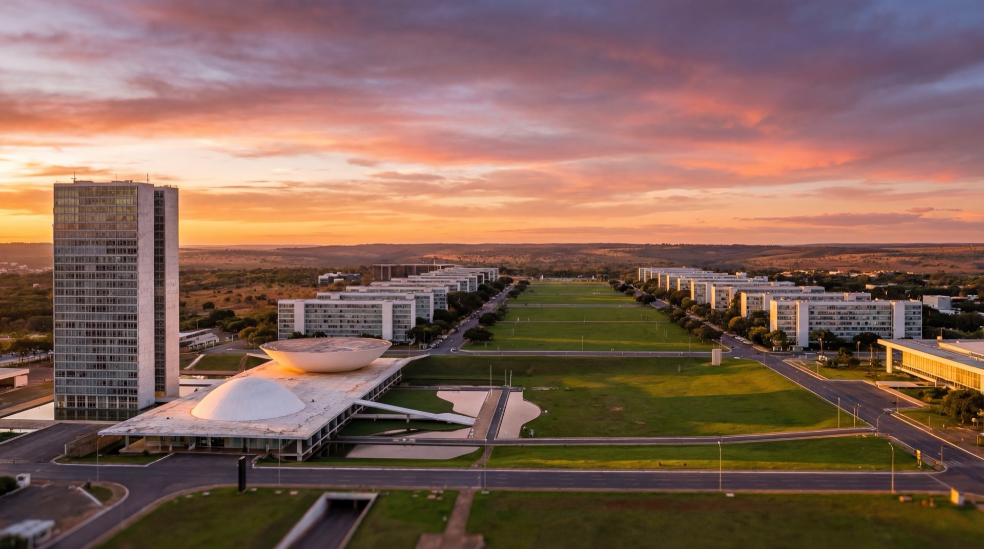 Panoramic view of Brasília at sunset with the National Congress building, Esplanada dos Ministérios, and the modernist skyline designed by Oscar Niemeyer, warm golden light reflecting off white concrete structures against the cerrado landscape