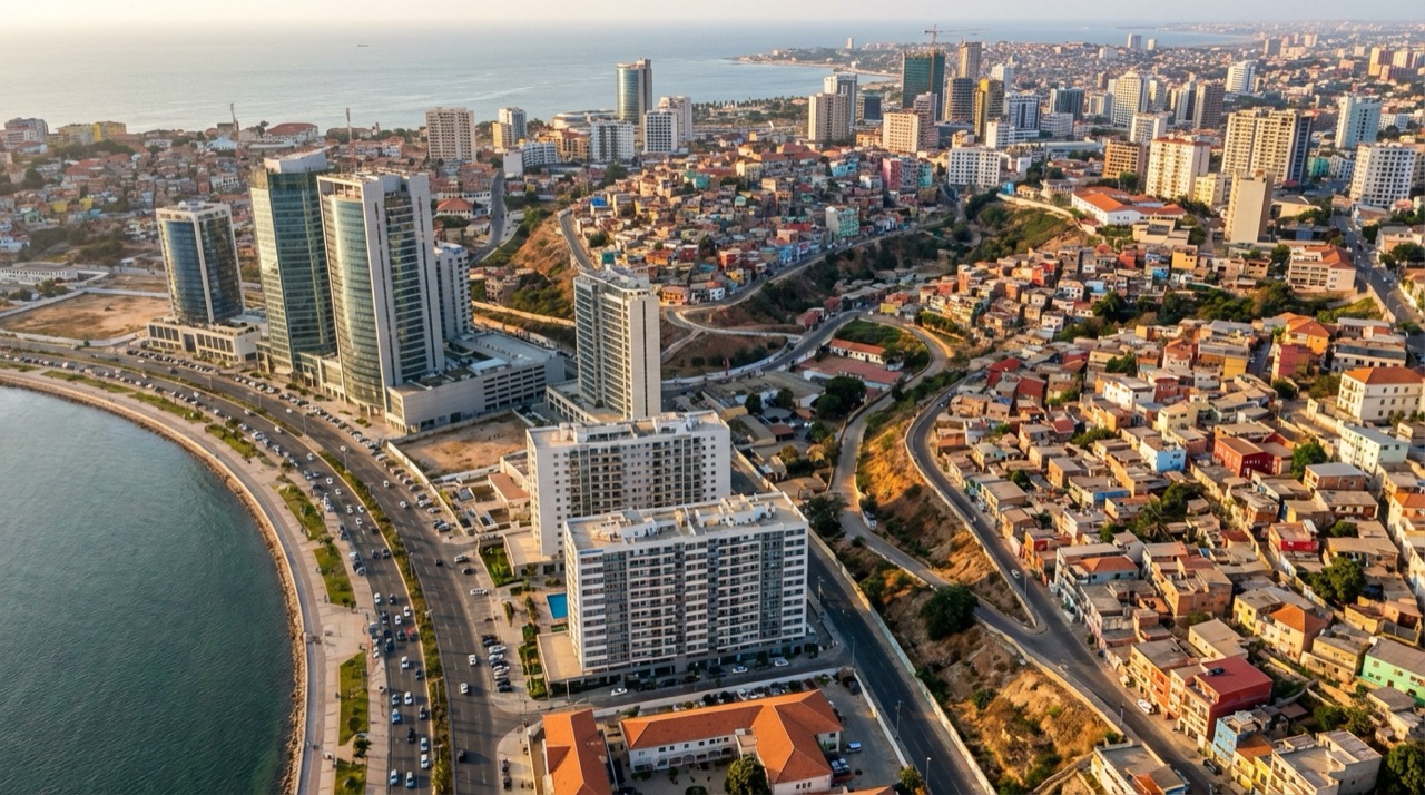 Aerial view of Luanda showing contrast between modern high-rises along the bay and colorful traditional neighborhoods on the hillsides